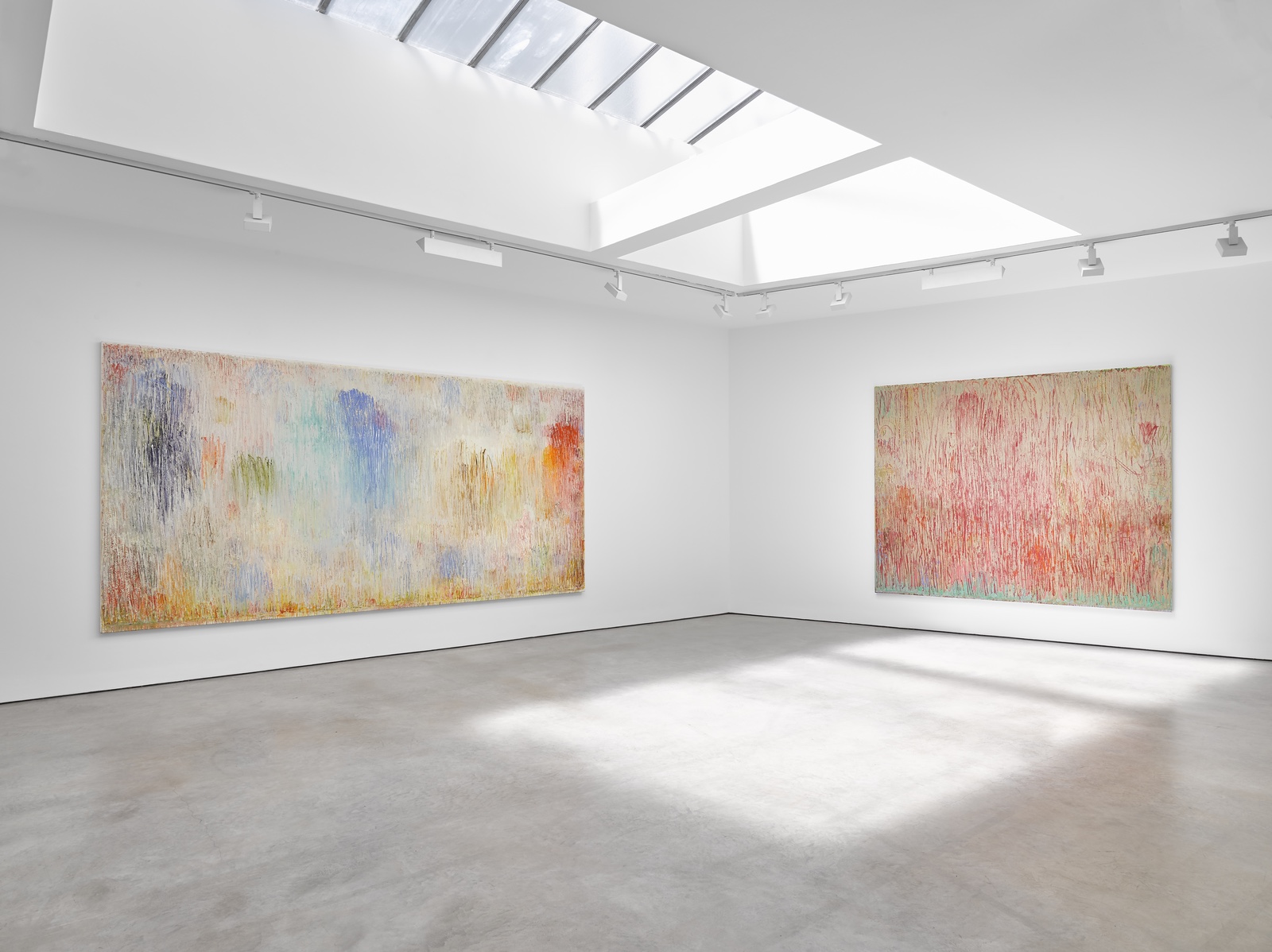A gallery interior hung with contemporary paintings